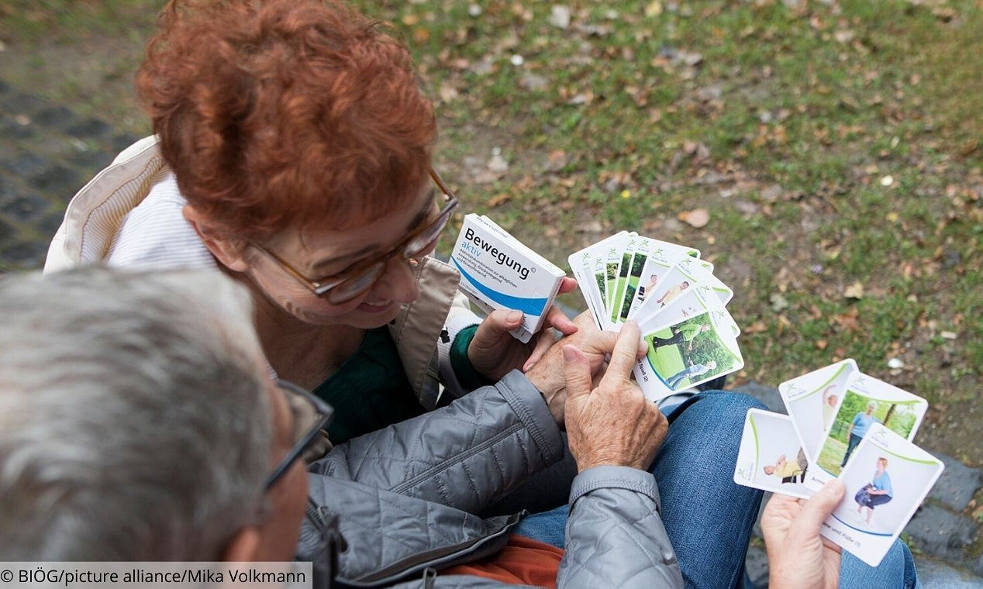 Gruppe älterer Menschen mit Karten der Bewegungspackung